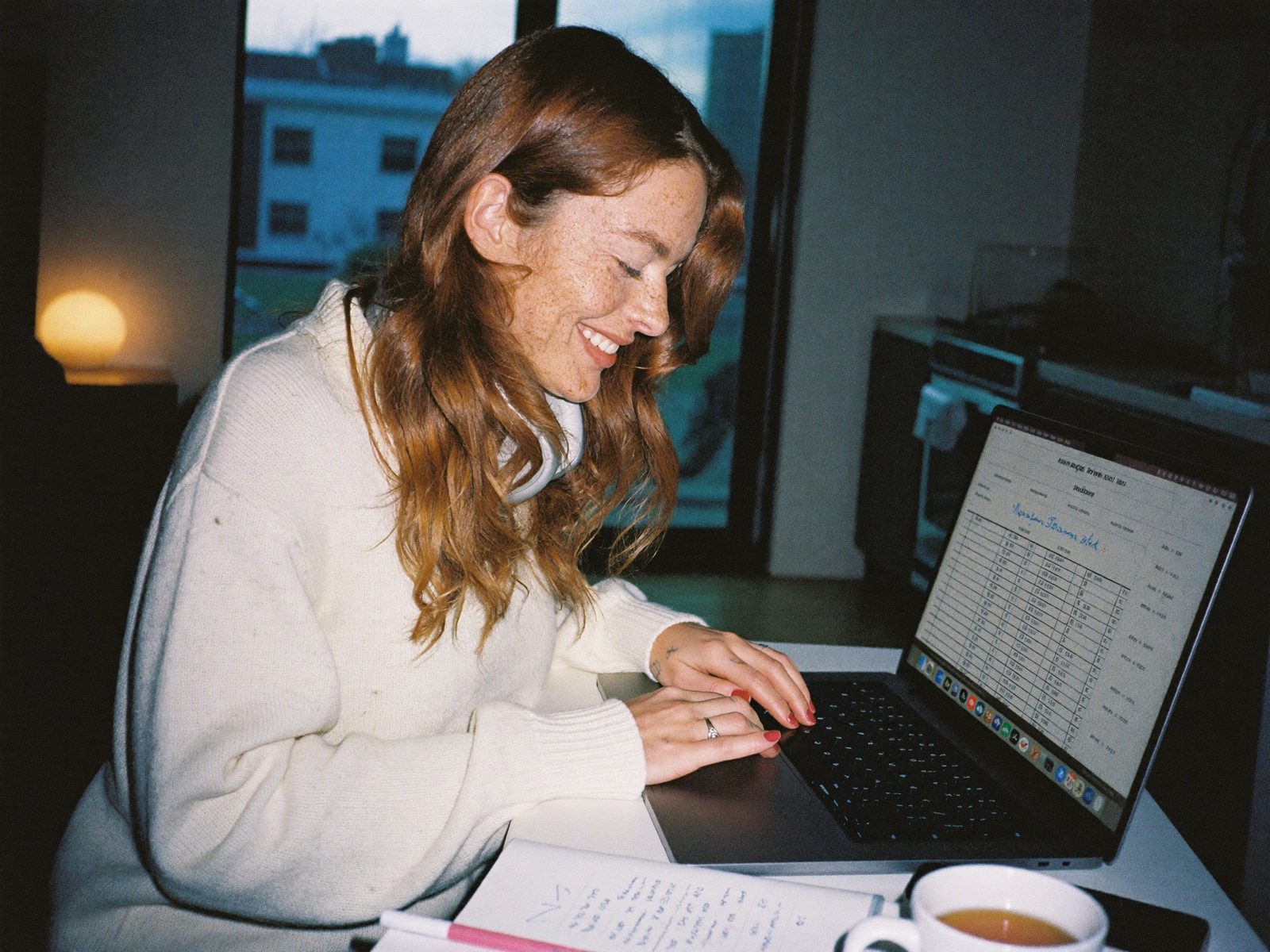 Student studying bookkeeping on a laptop in the evening